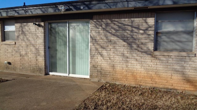 view of side of home with a patio