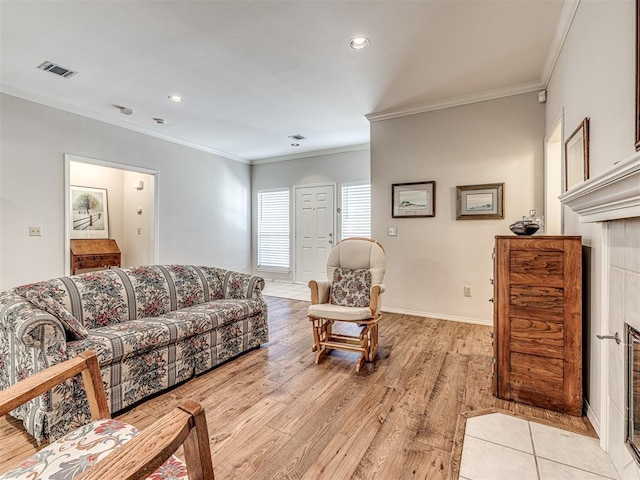 living room with ornamental molding and light wood-type flooring