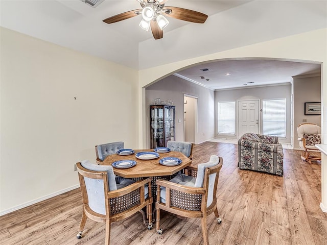 dining area featuring ceiling fan, ornamental molding, and light hardwood / wood-style floors