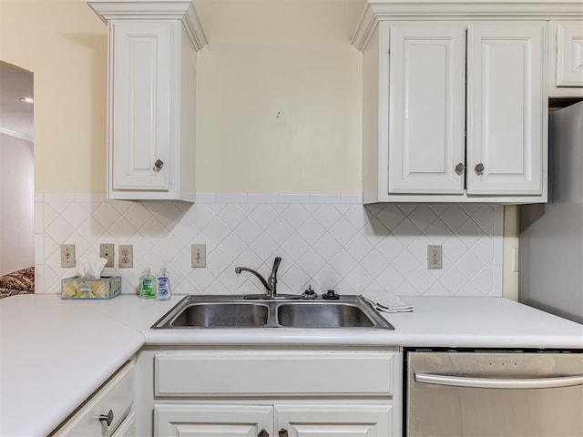 kitchen with white cabinets, backsplash, sink, and dishwasher