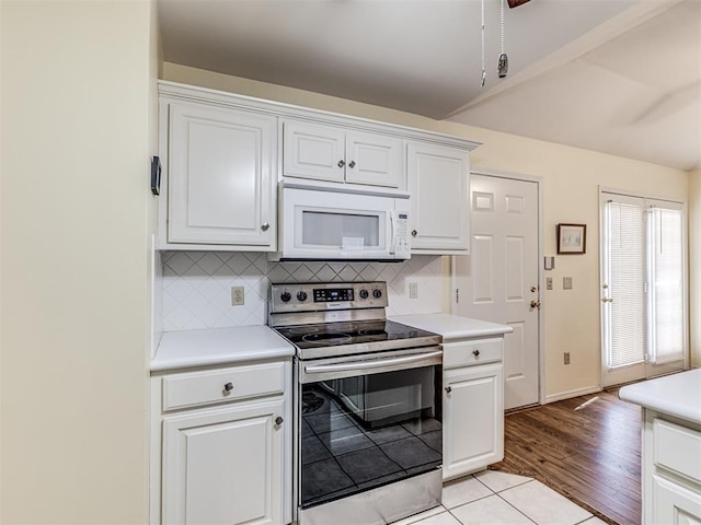 kitchen with white cabinetry, electric range, and decorative backsplash