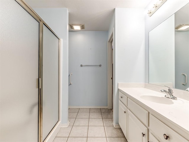 bathroom featuring an enclosed shower, vanity, and tile patterned floors