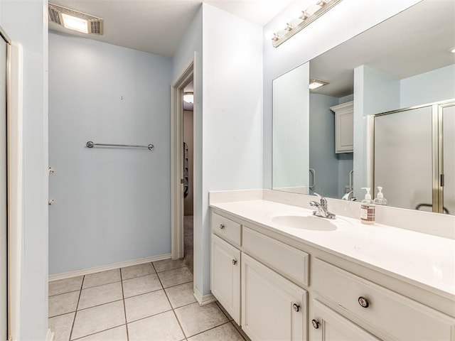 bathroom featuring walk in shower, tile patterned floors, and vanity