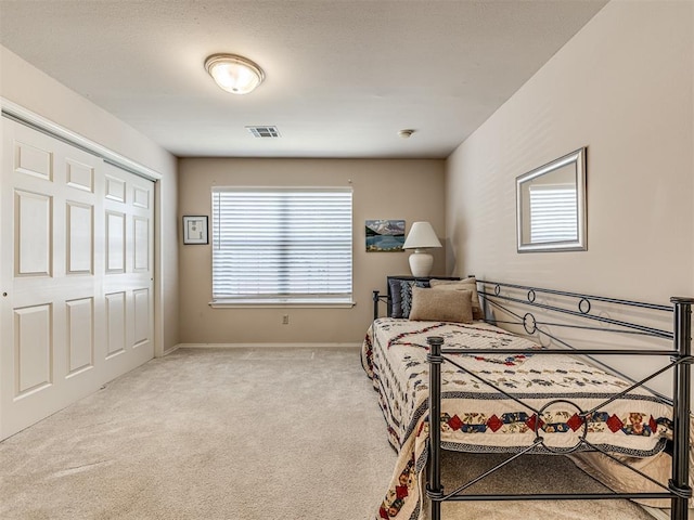 carpeted bedroom featuring a closet