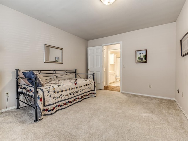 carpeted bedroom with ensuite bathroom