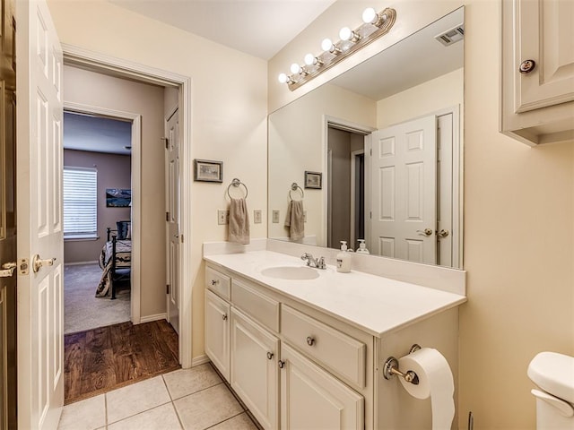 bathroom with vanity, toilet, and tile patterned flooring