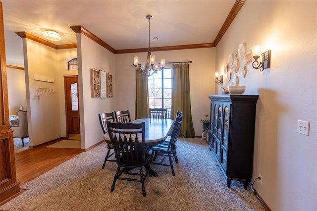 carpeted dining space with crown molding and a notable chandelier