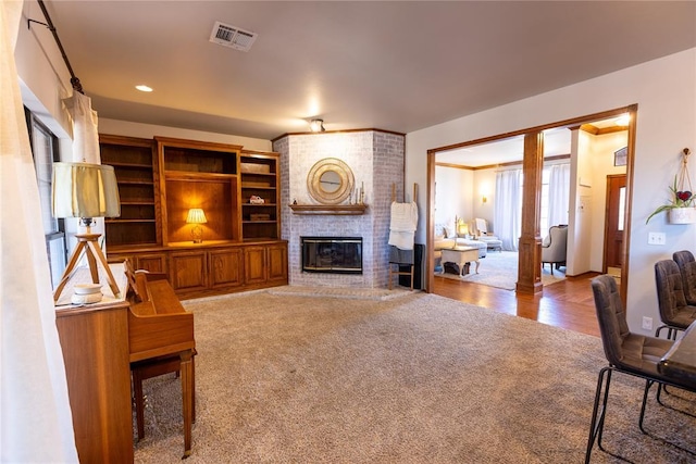 carpeted living room with a fireplace