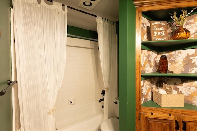 bathroom featuring toilet and shower / bath combo with shower curtain