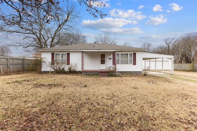 single story home with a front yard and a carport