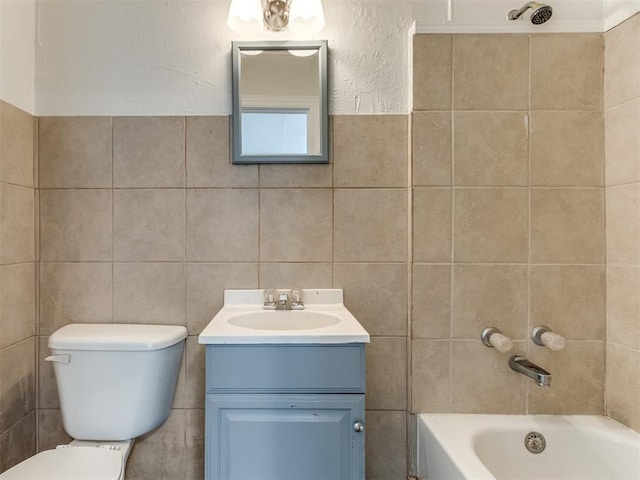 full bathroom with vanity, toilet, shower / bathing tub combination, and tile walls