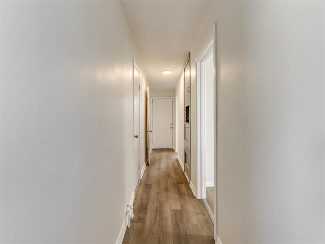 corridor featuring wood-type flooring