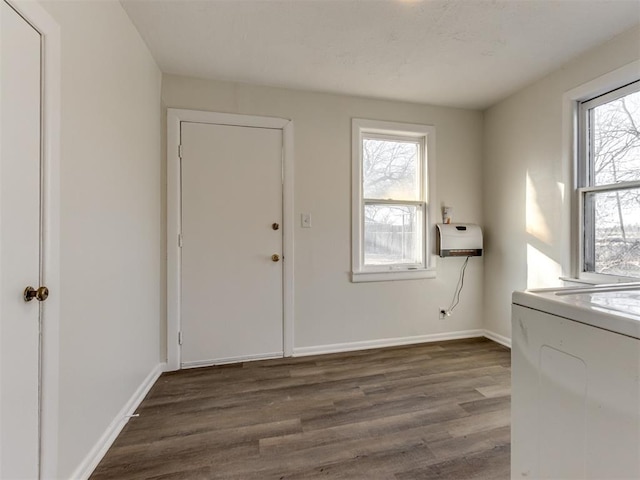 interior space featuring washer / dryer, dark hardwood / wood-style floors, and heating unit