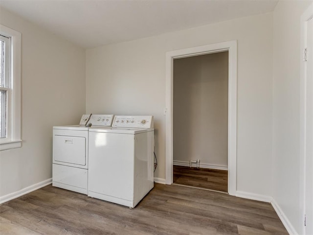 laundry room with wood-type flooring and washing machine and clothes dryer