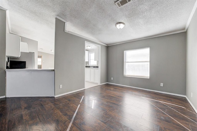 unfurnished living room with crown molding, dark wood-type flooring, and vaulted ceiling