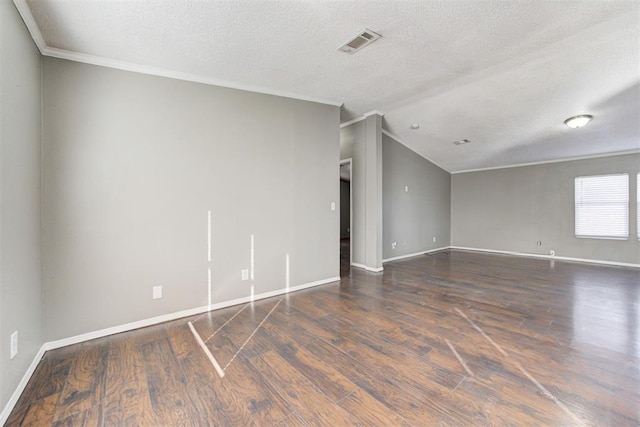 empty room featuring a textured ceiling, dark hardwood / wood-style floors, and lofted ceiling