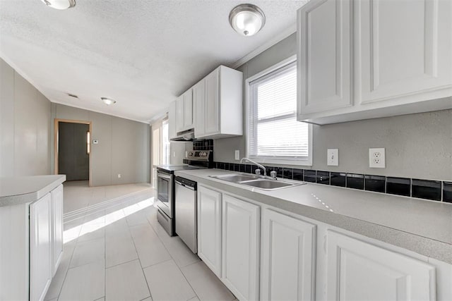 kitchen featuring sink, white cabinetry, light tile patterned flooring, lofted ceiling, and stainless steel appliances