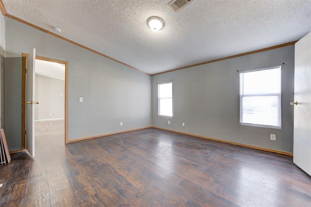 spare room featuring a textured ceiling, dark hardwood / wood-style floors, lofted ceiling, and ornamental molding