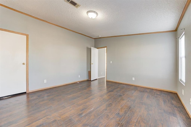 unfurnished room with crown molding, dark wood-type flooring, a textured ceiling, and plenty of natural light