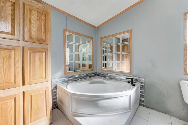 bathroom featuring a bath, vaulted ceiling, tile patterned floors, and ornamental molding