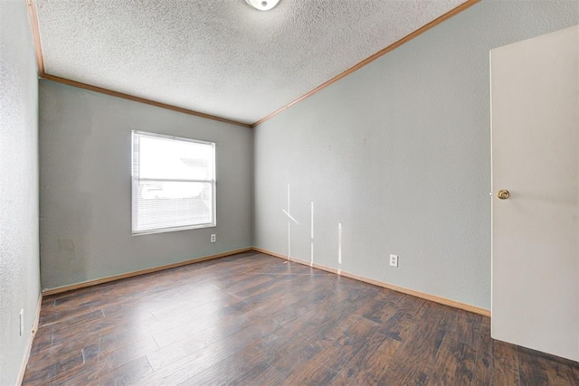 empty room with a textured ceiling, dark hardwood / wood-style flooring, and ornamental molding