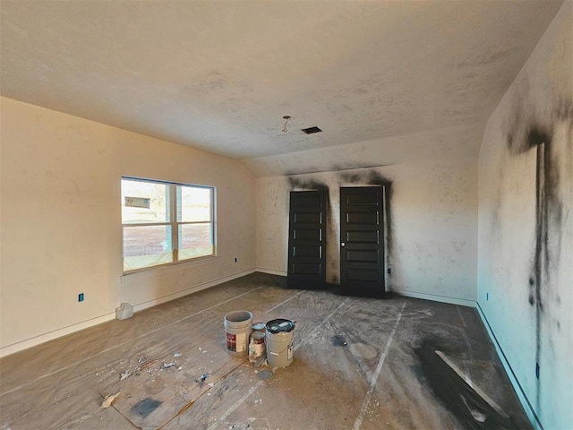 empty room with vaulted ceiling