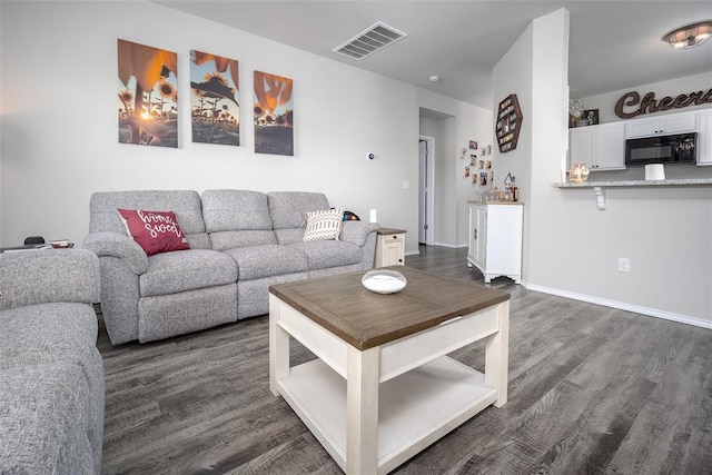 living room with dark hardwood / wood-style floors