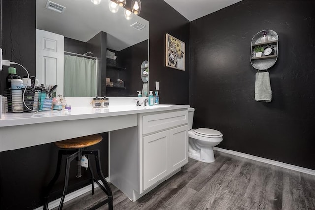 bathroom with vanity, hardwood / wood-style floors, a shower with curtain, and toilet