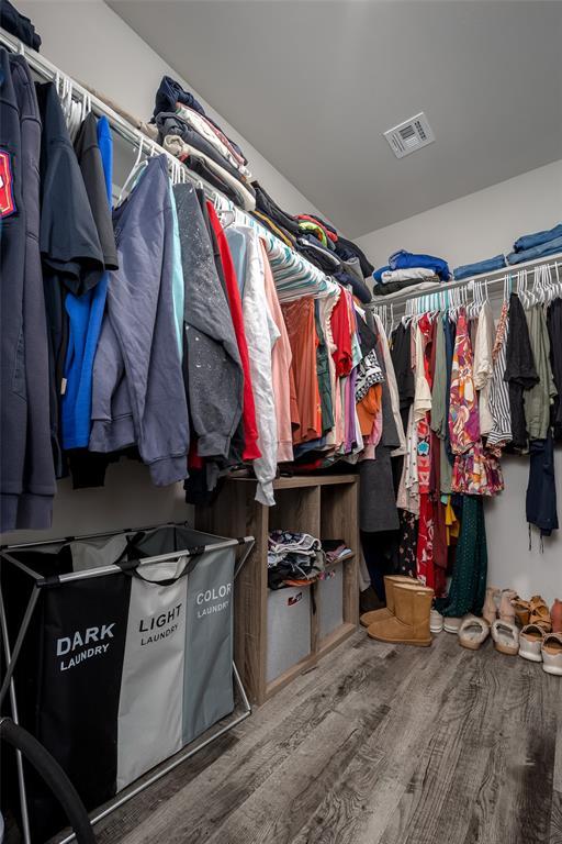 spacious closet featuring hardwood / wood-style floors