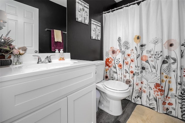 bathroom featuring vanity, curtained shower, and toilet