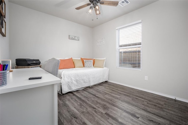 bedroom featuring ceiling fan and dark hardwood / wood-style floors