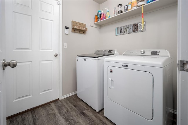 clothes washing area featuring dark hardwood / wood-style floors and washing machine and dryer