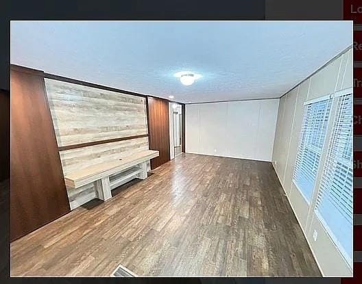 interior space with dark wood-type flooring and a textured ceiling