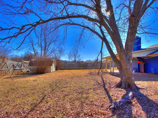 view of yard with a shed and a playground