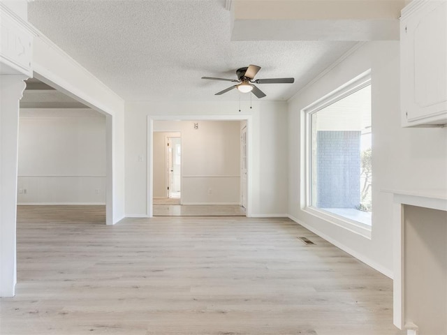 unfurnished living room with ceiling fan, crown molding, a textured ceiling, and light hardwood / wood-style floors