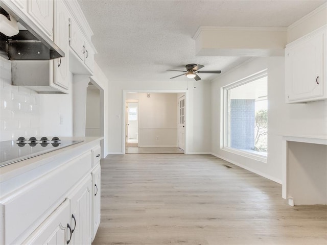 kitchen with white cabinetry, range hood, tasteful backsplash, electric cooktop, and light wood-type flooring