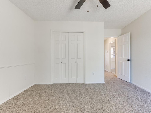 unfurnished bedroom featuring a closet, a textured ceiling, and carpet