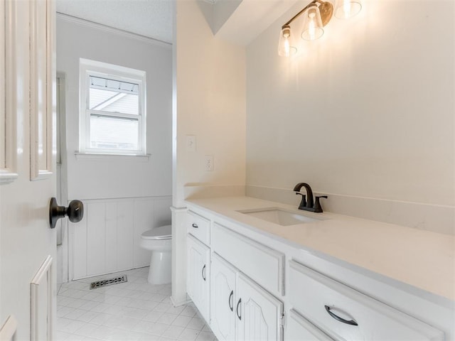 bathroom with tile patterned floors, vanity, toilet, and a textured ceiling