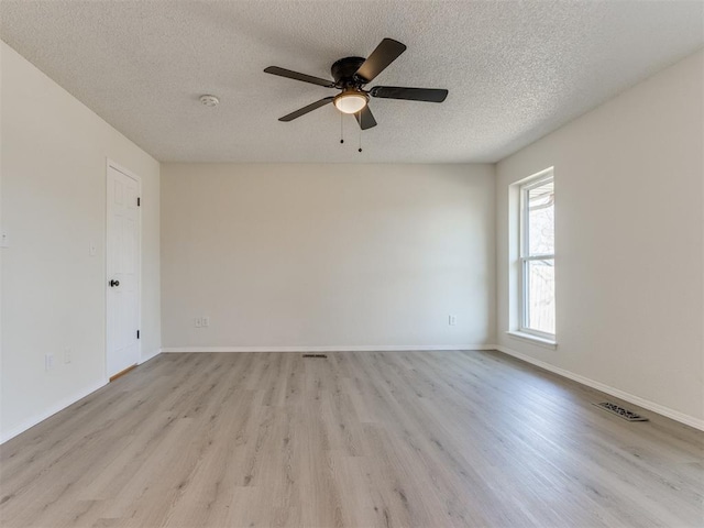 unfurnished room with ceiling fan, a textured ceiling, and light hardwood / wood-style flooring