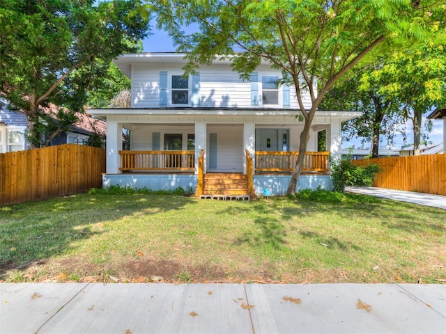 view of front of property featuring covered porch and a front lawn