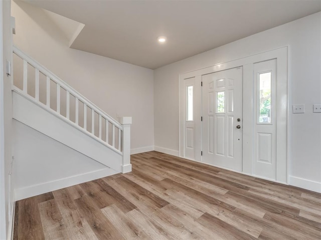 foyer entrance with light hardwood / wood-style floors