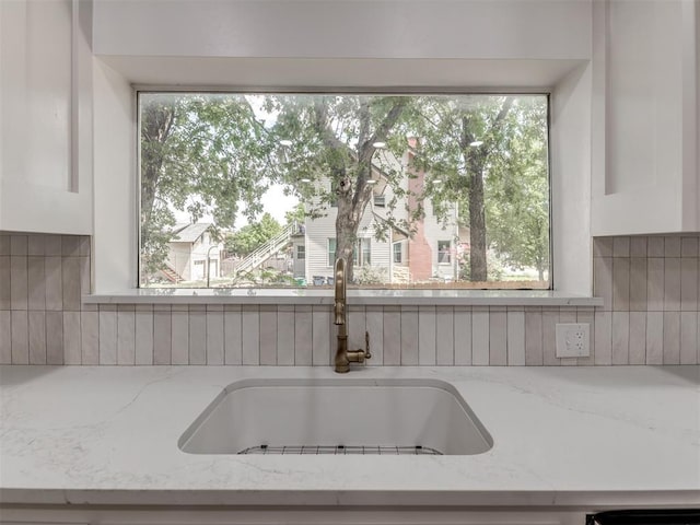 details with light stone countertops and sink