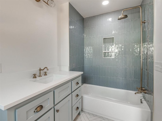 bathroom with tiled shower / bath, vanity, and tile patterned floors