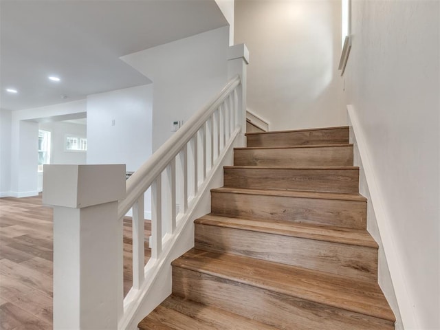 stairs with wood-type flooring