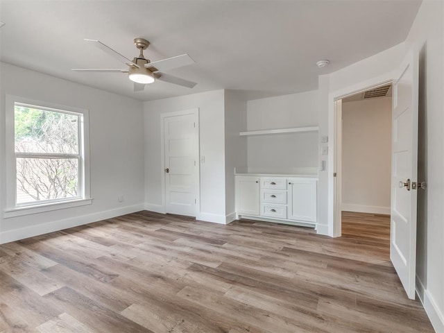 unfurnished bedroom with ceiling fan and light wood-type flooring