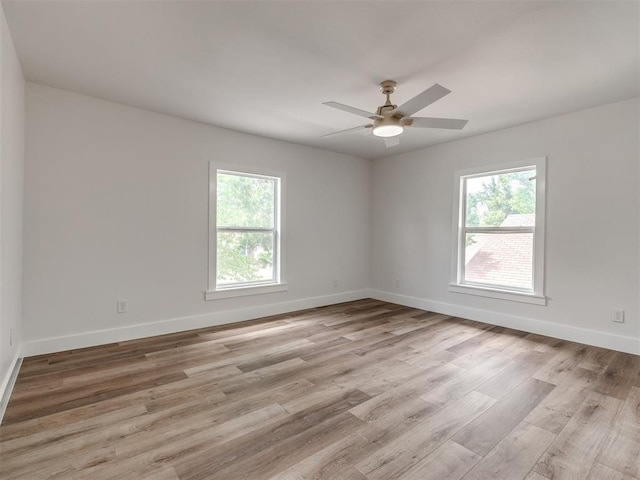 unfurnished room with ceiling fan and light wood-type flooring