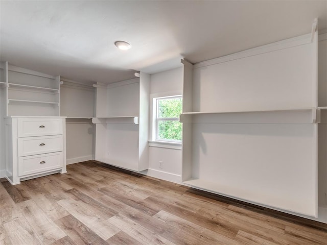 spacious closet featuring light hardwood / wood-style floors