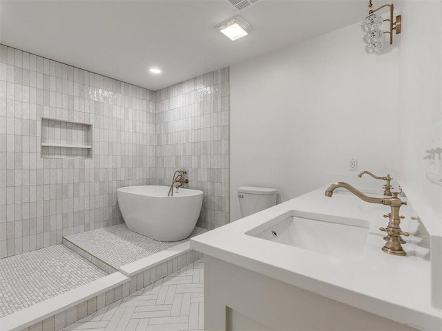 bathroom with vanity, toilet, a bathing tub, and tile walls