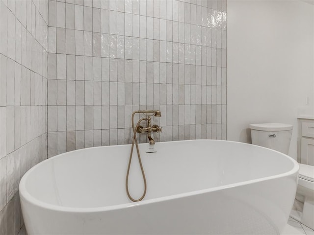 bathroom featuring toilet, tile walls, and a tub to relax in