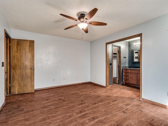 unfurnished room with ceiling fan, hardwood / wood-style flooring, and a textured ceiling